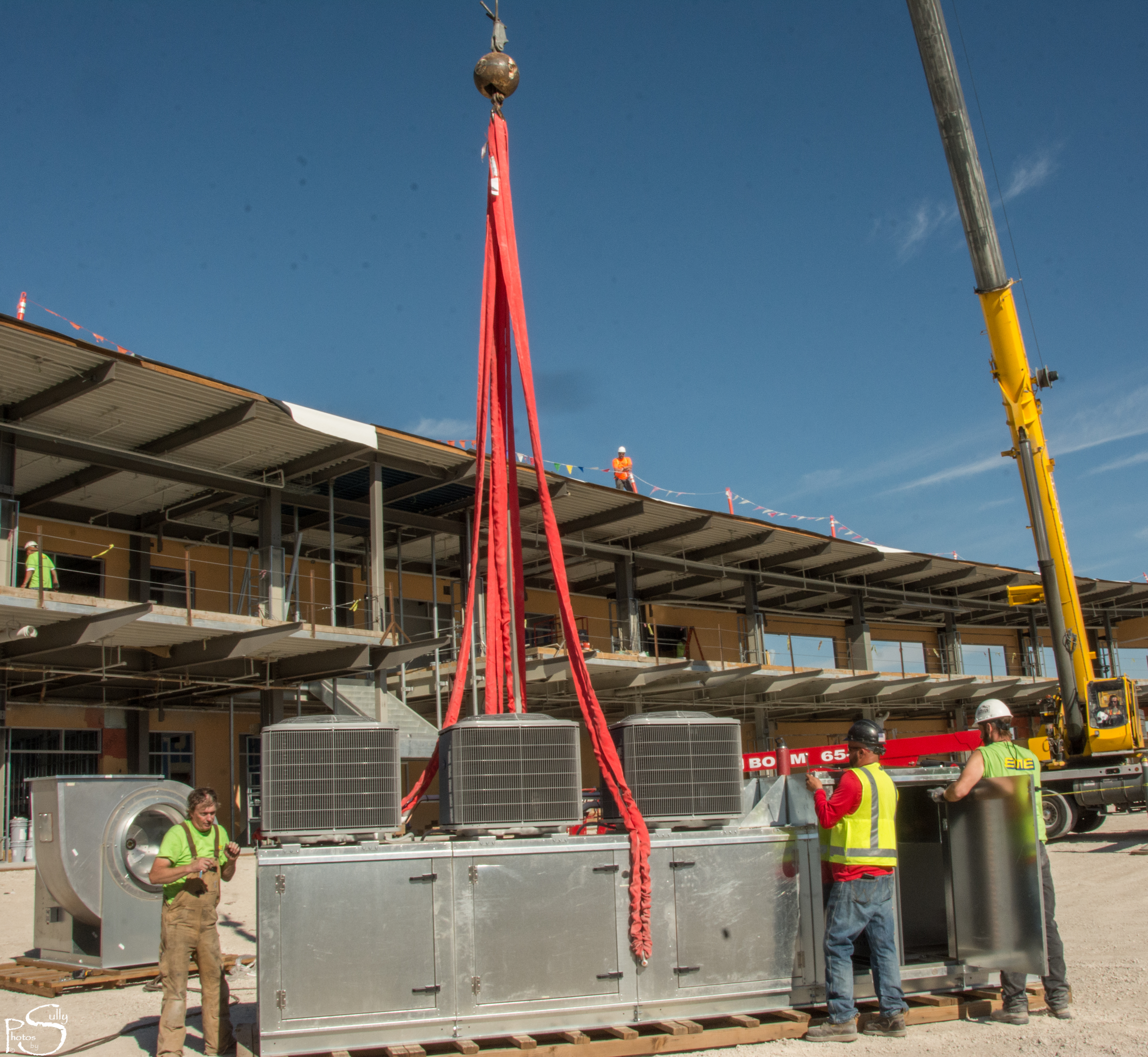 A crane about to pick up an HVAC system